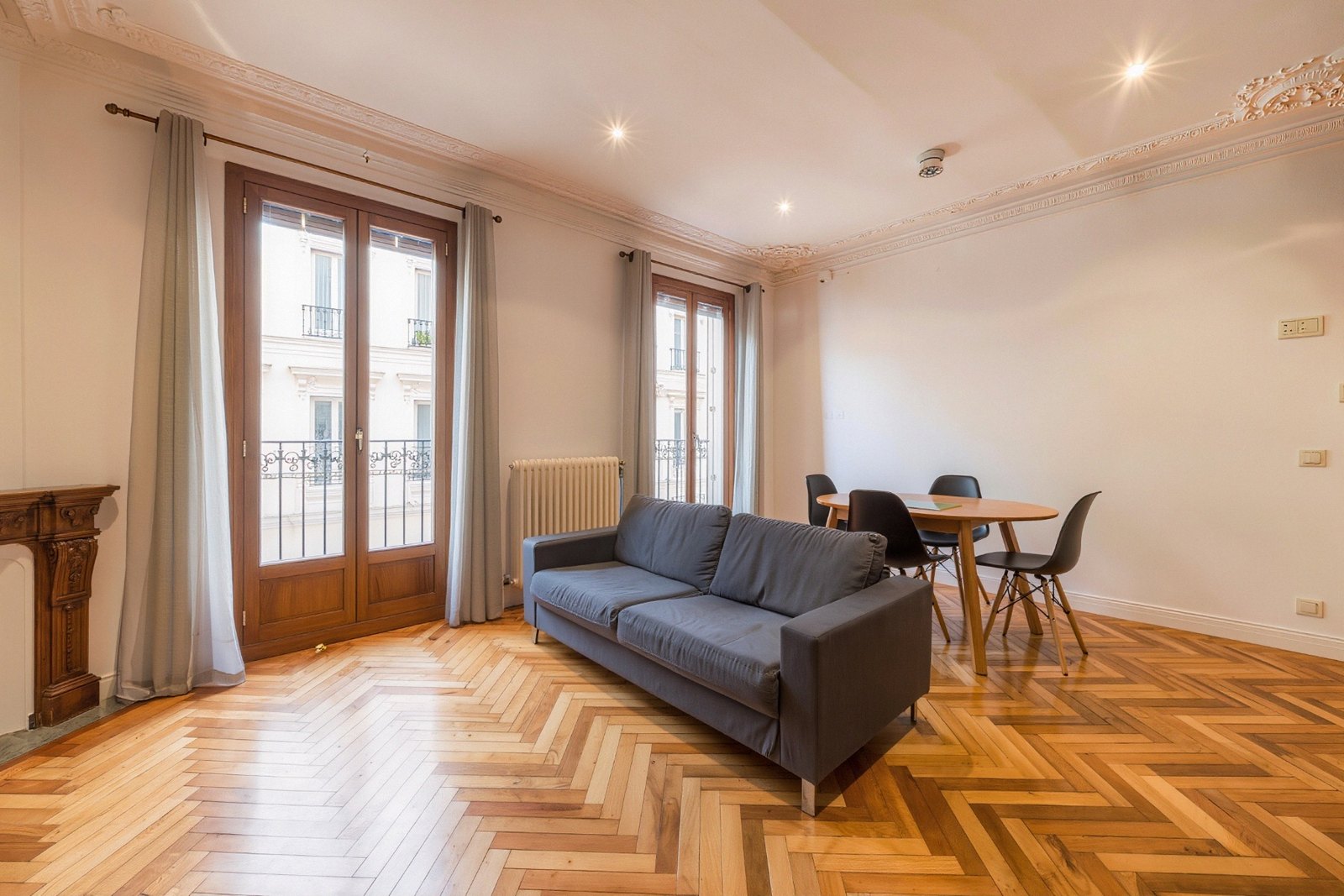 Living room with French windows and wrought-iron balconies